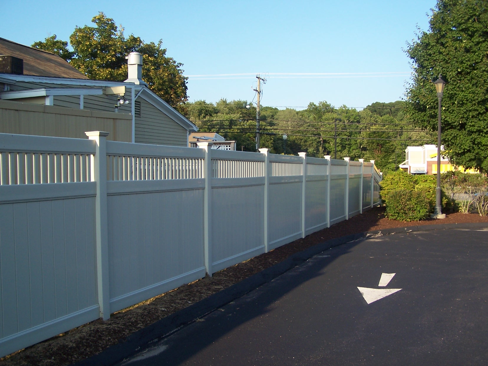 White and gray vinyl privacy fence with picket section installed at a Connecticut home