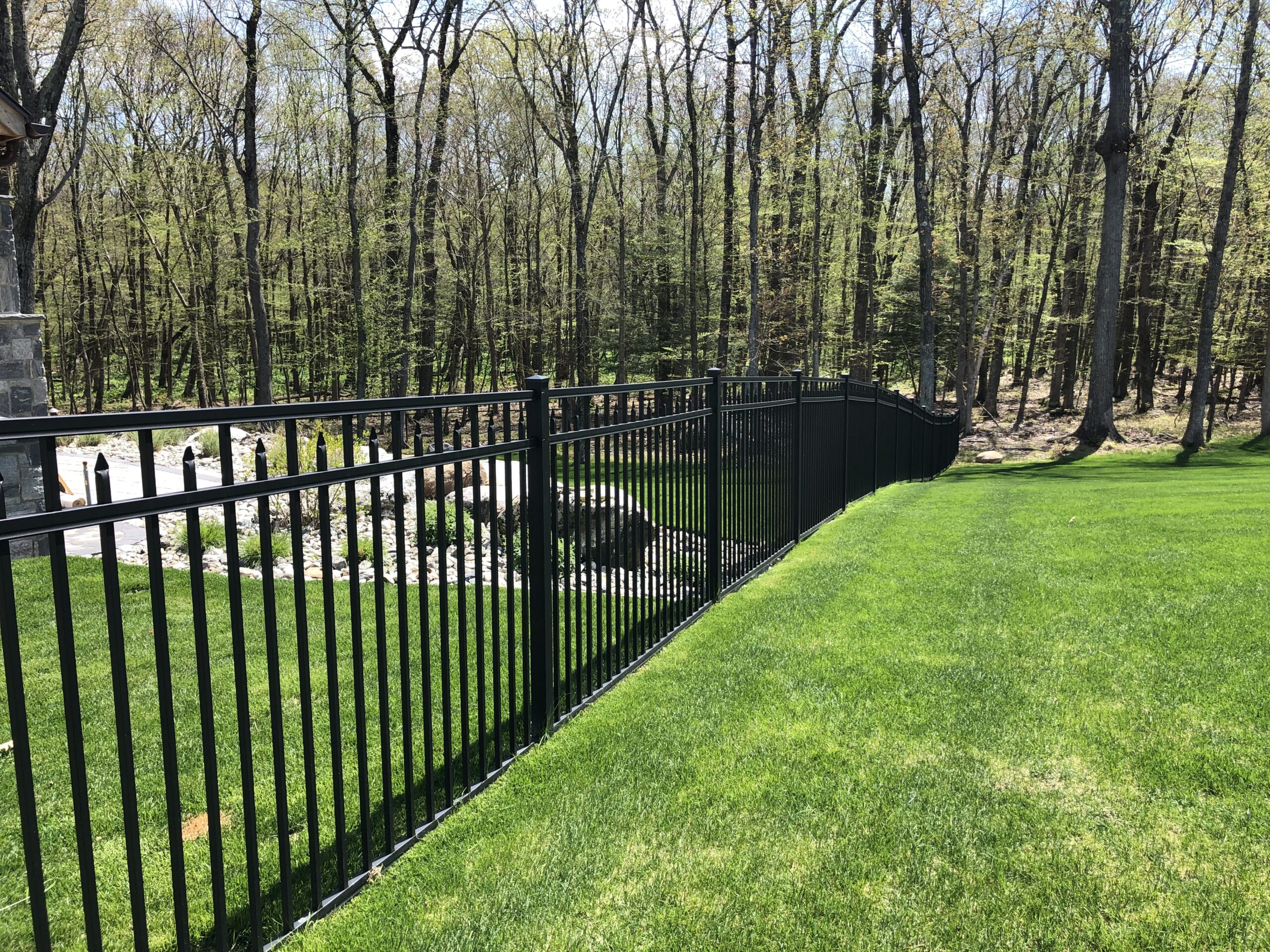 Aluminum fence enclosing a Connecticut backyard for pet safety and containment