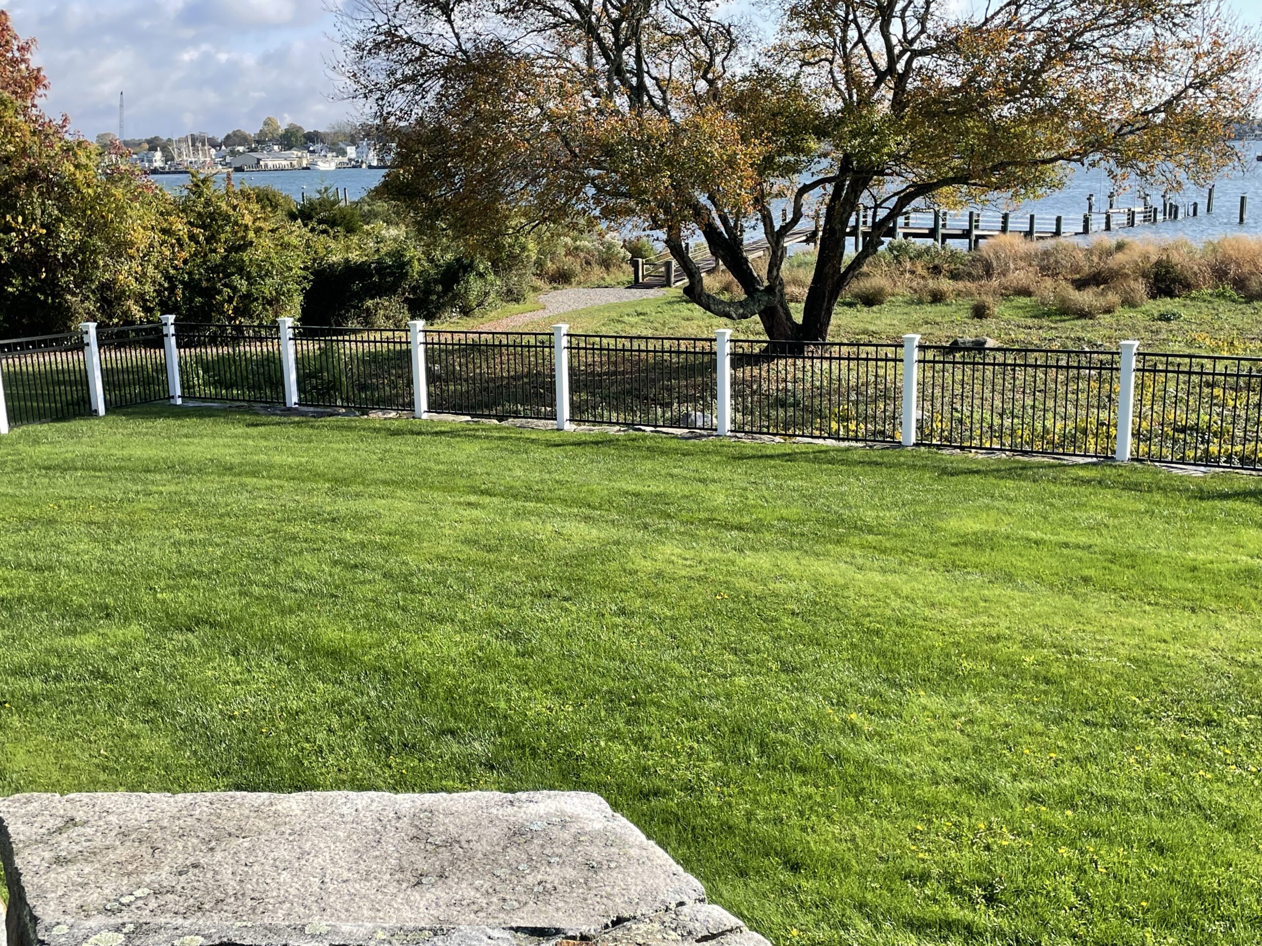 Residential black aluminum fence defining a Connecticut backyard perimeter