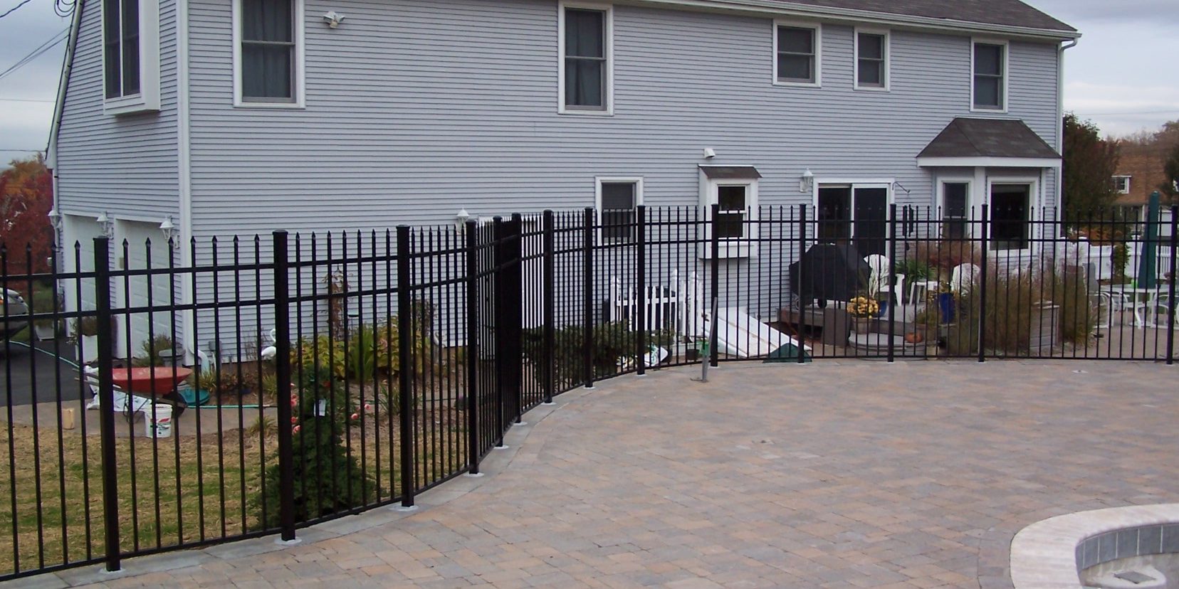 Classic black aluminum fence panel installed by Arrow Fence showcasing clean lines