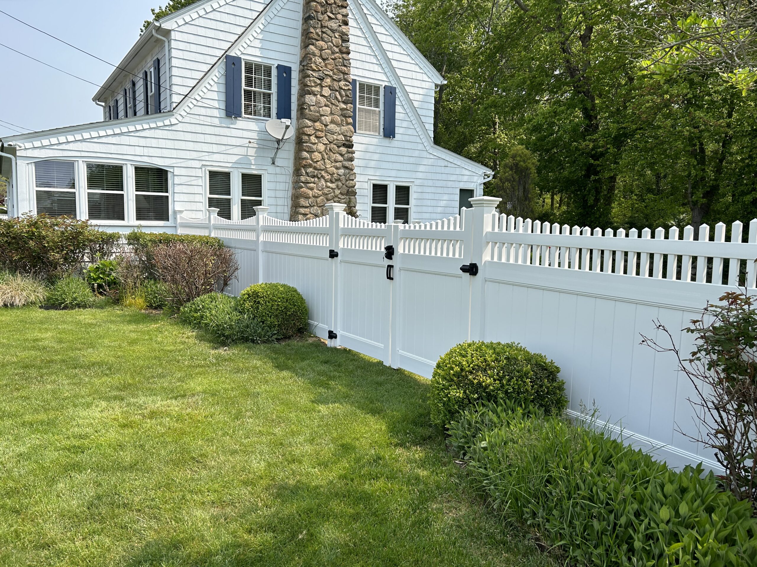 Beautiful white vinyl privacy fence with scalloped topper installed by Arrow Fence in Connecticut — available with flexible financing