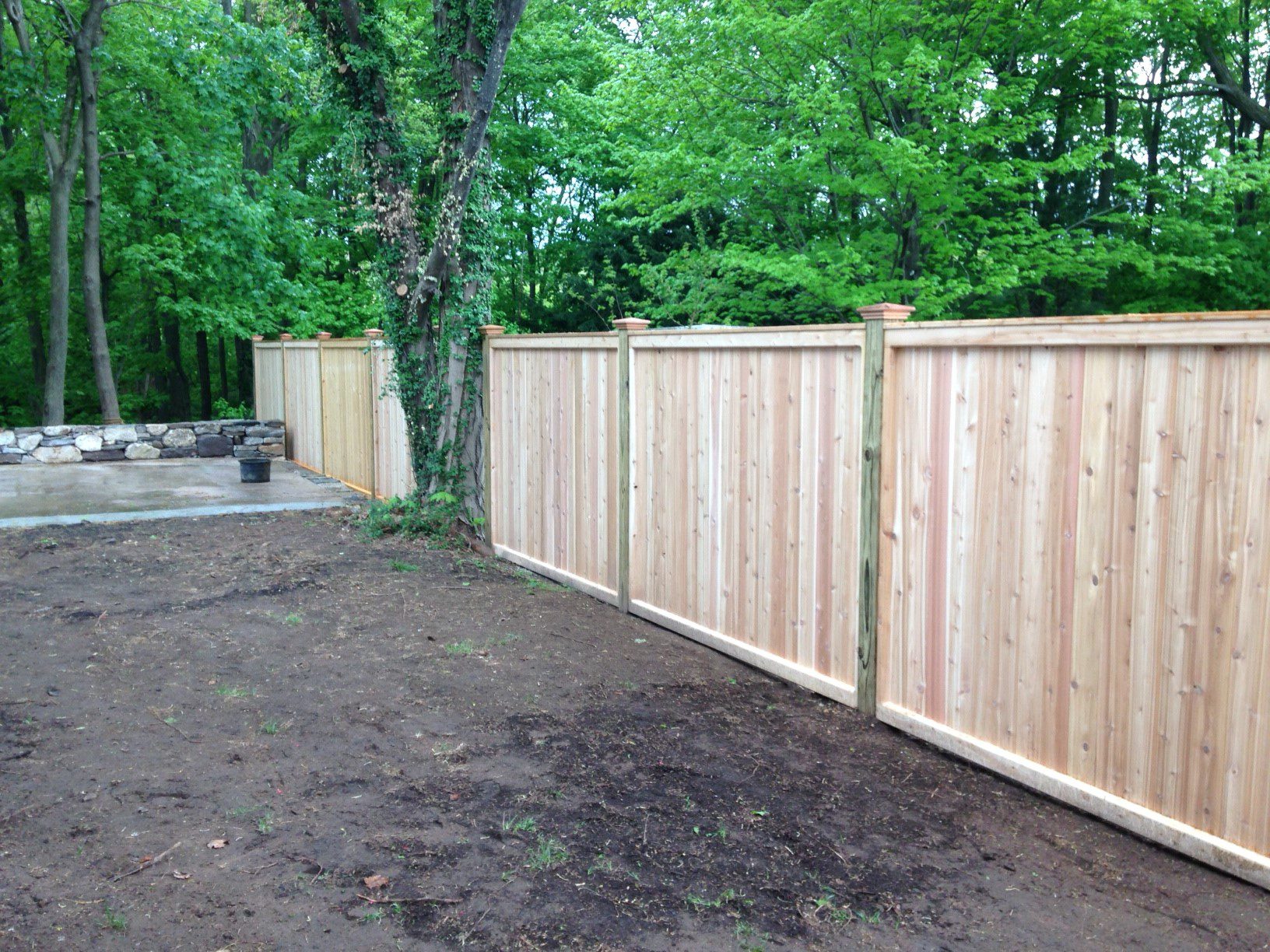 Tongue-and-groove cedar privacy fence with pressure-treated posts installed by Arrow Fence in Connecticut