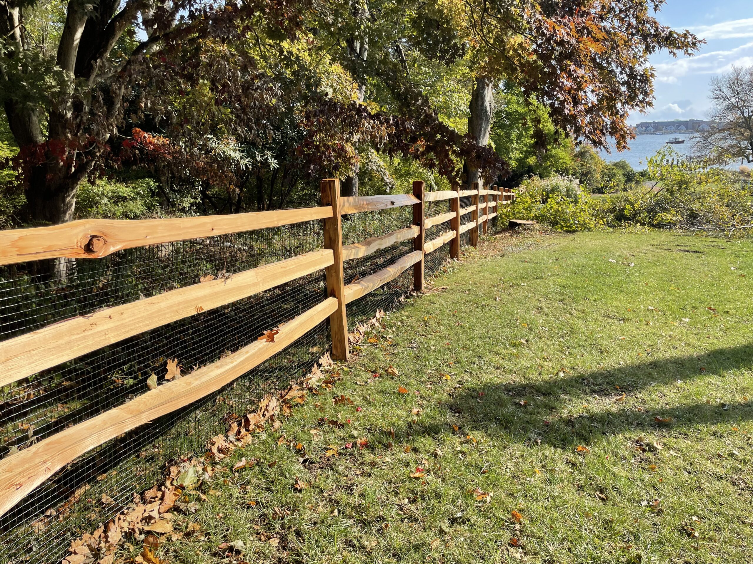 Western red cedar split rail fence in an autumn Connecticut landscape by Arrow Fence