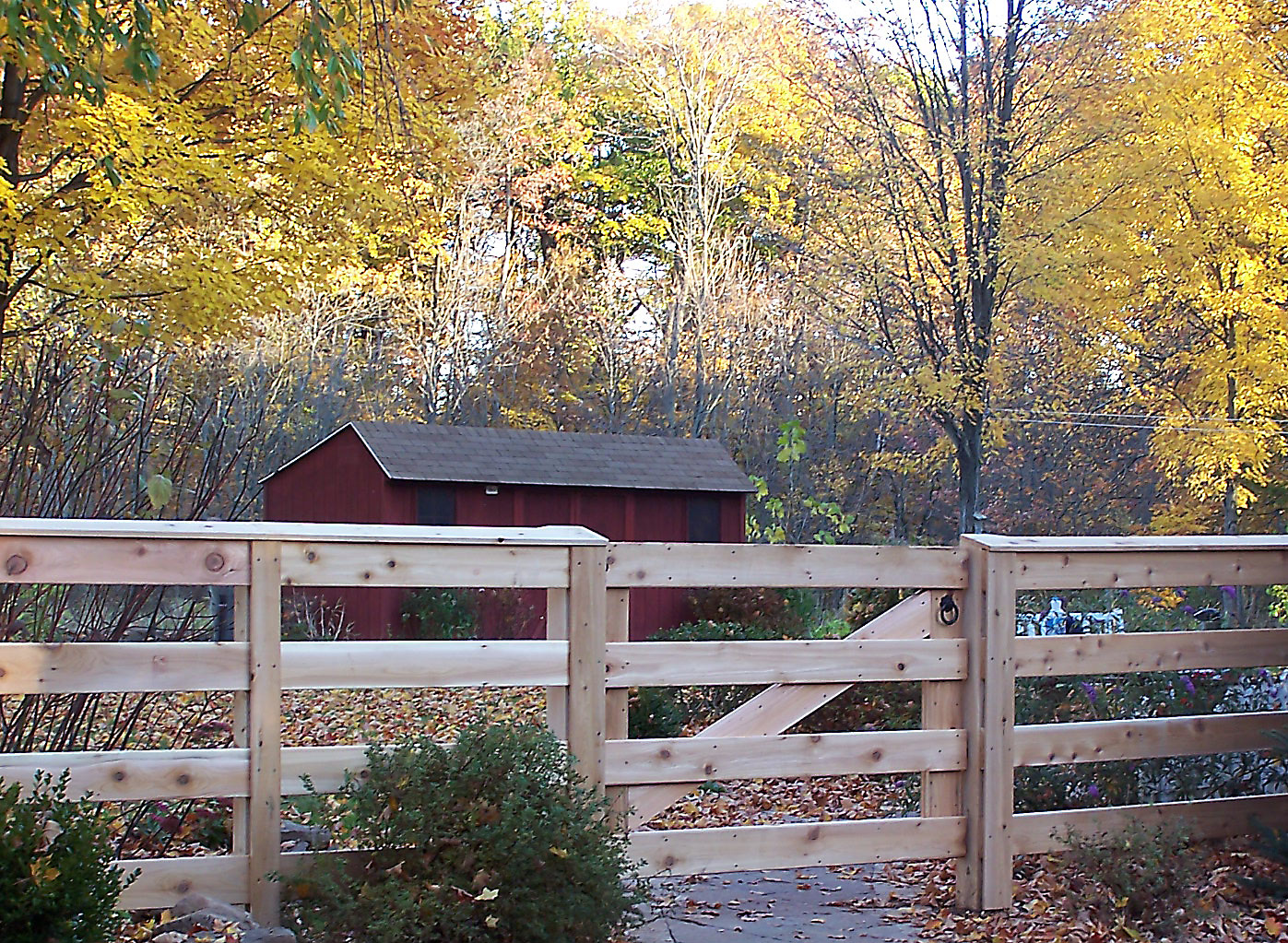 Four-rail cedar board fence showing horizontal board style installed by Arrow Fence in Connecticut