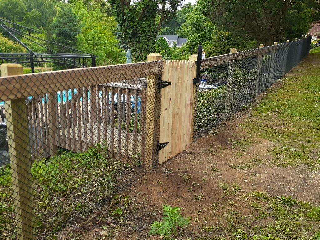 California-style horizontal board rail fence around a pool area in Connecticut