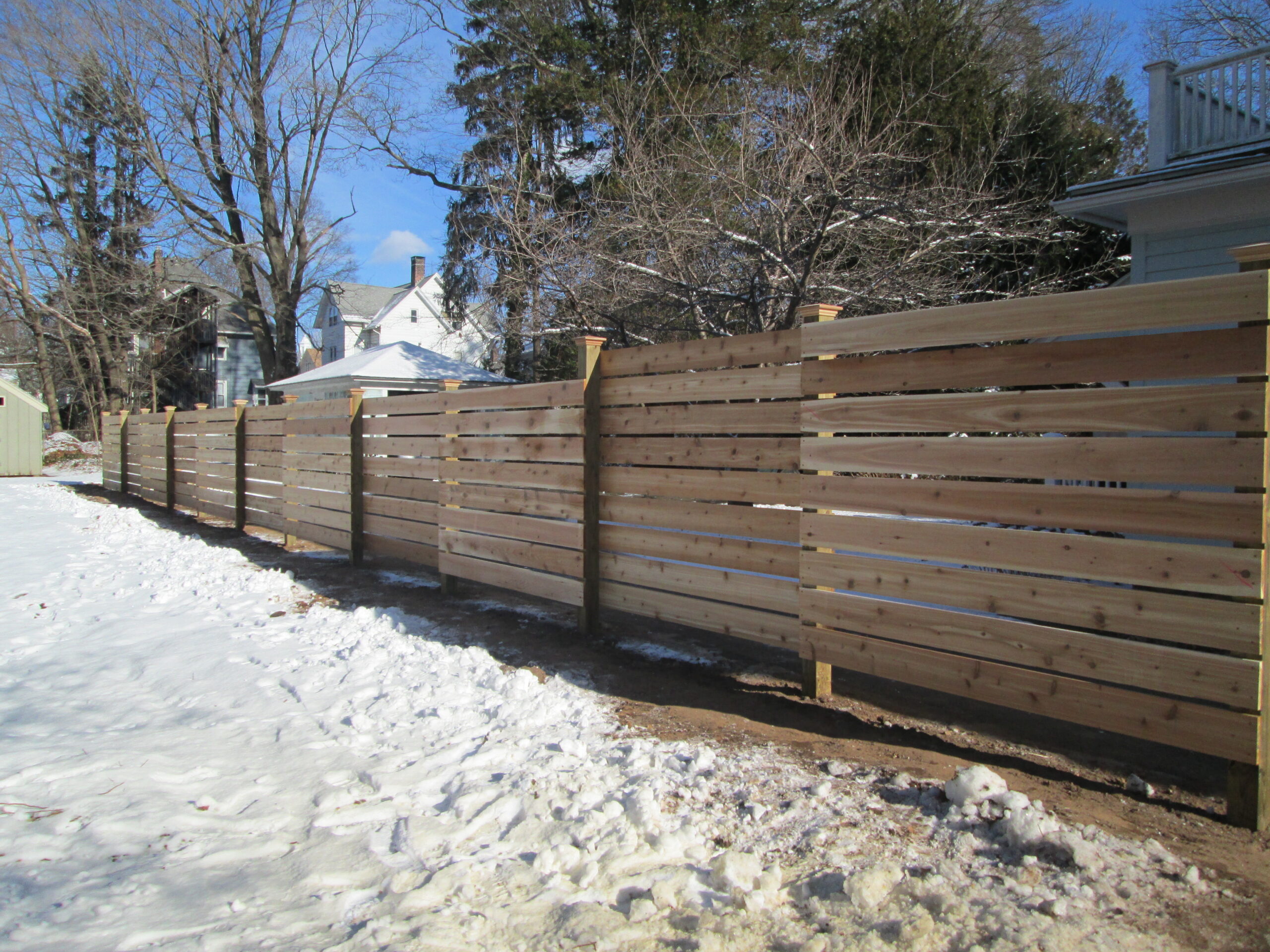 Horizontal board rail fence showing modern rail style installed by Arrow Fence in Connecticut