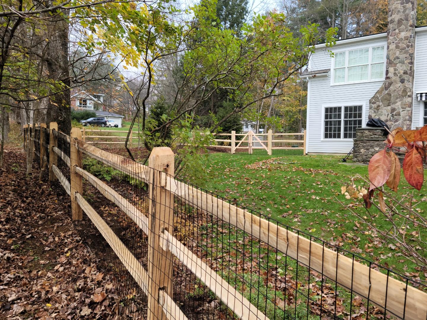 Split rail fence enclosing a Connecticut backyard installed by Arrow Fence