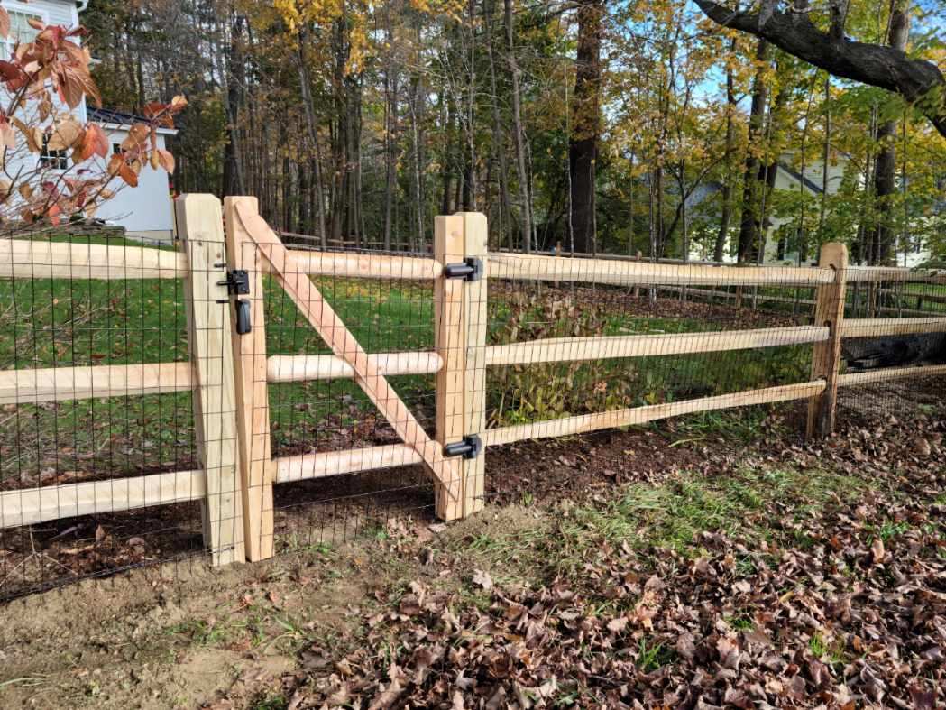 Traditional split rail fence with wire mesh backing installed by Arrow Fence in Connecticut